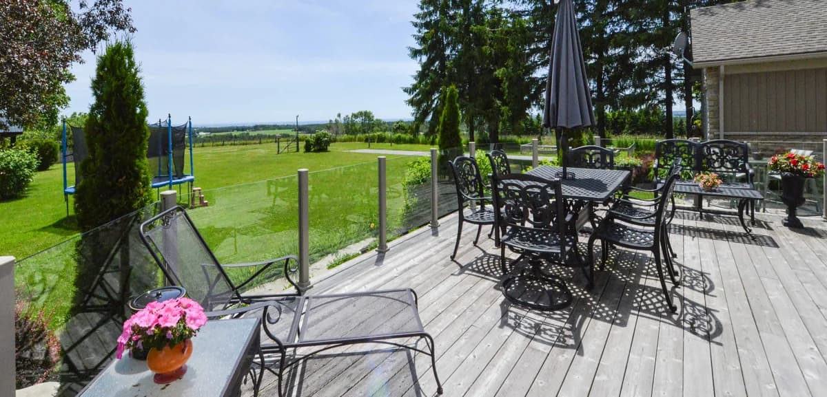 Frameless glass railing system overlooking a backyard patio