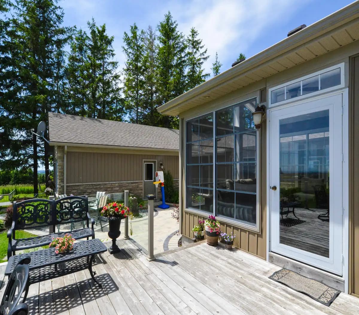 Contemporary topless glass railing along a curved deck edge