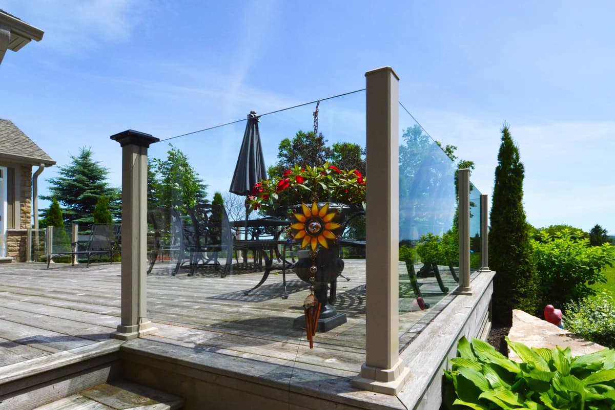 Topless glass railing installed on a multi-level outdoor deck
