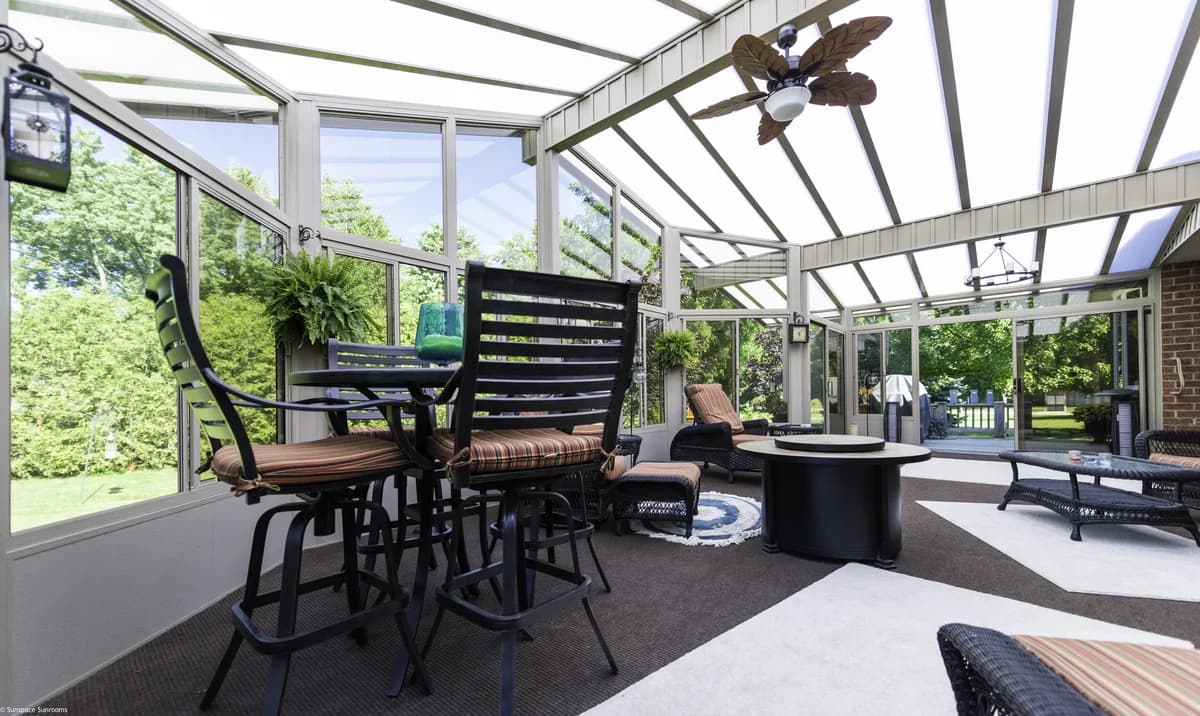Bright sunroom interior view with panoramic windows