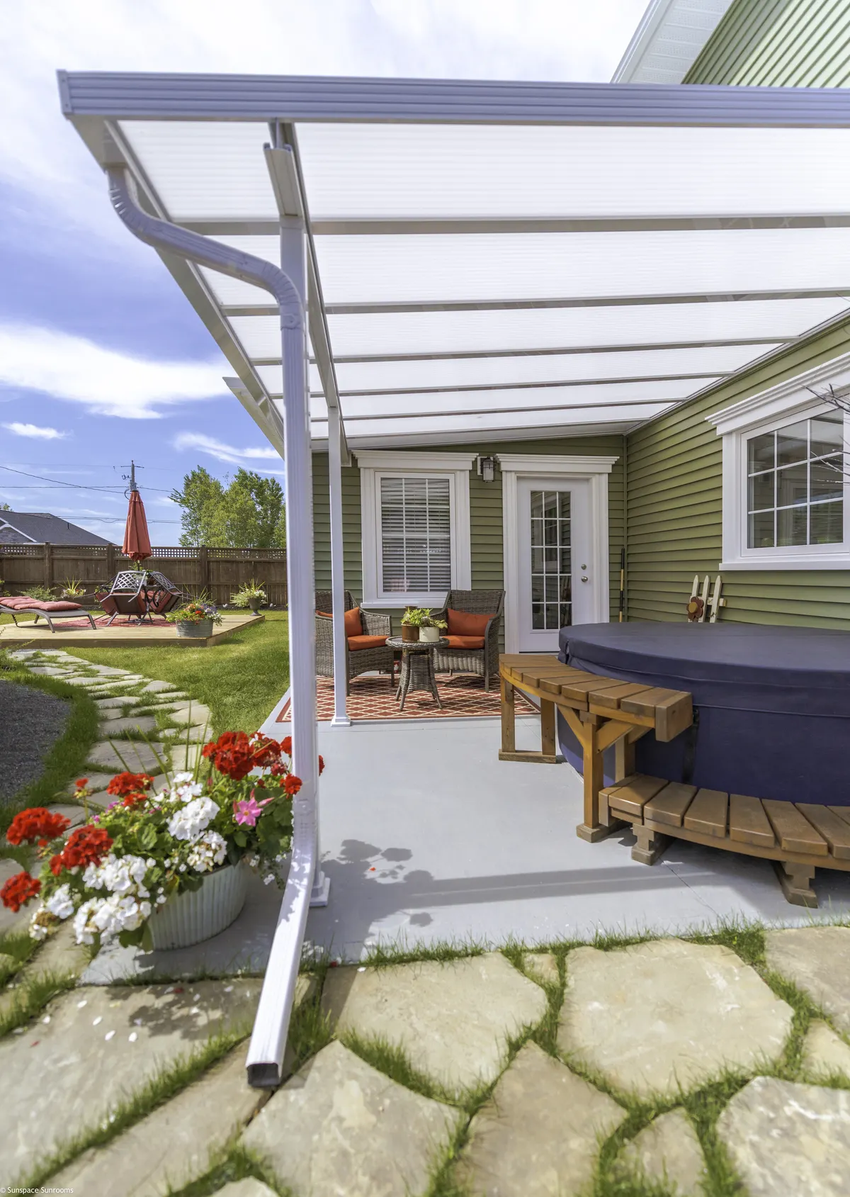 Acrylic patio cover over a hot tub patio